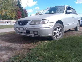 Mazda Capella 1999 года выпуска, цвет светло-серый, VIN отсутствует.