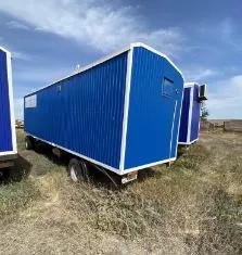 Прицеп вагон дом передвижной 87703, идентификационный номер VIN: X89877030F00EV133, год изготовления 2015, цвет синий, разрешенная максимальная масса 7700 кг, масса без нагрузки 7700 кг.,  государственный регистрационный знак АС 9898 56