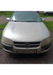 Opel Omega 1996 года выпуска, цвет серебристый (белый), номерной знак MO86MB13, VIN: W0L000026T1115447. Автомобиль на ходу, на зимней резине. Прогорела выхлопная система, климат не работает, трещина на лобовом стекле, проблемы с маслом. Основные лампочки горят. Горит чек, на движение не влияет…