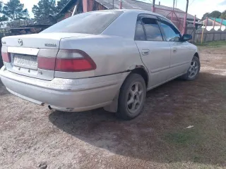 Mazda Capella 1999 года выпуска, цвет светло-серый, VIN отсутствует.