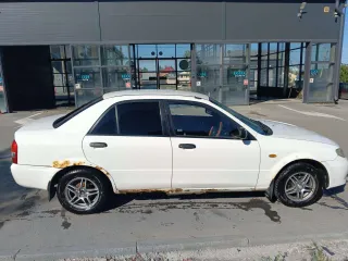 Mazda Familia, 2002. Легковой автомобиль, VIN: не установлен, мощность двигателя (кВт/л.с.): 63,75/85,0, гос. номер С224НН22. По кузову автомобиля присутствует коррозия, сгнившие пороги, арки, ржавчина на капоте, дверях и раме лобового стекла, пинается коробка с первой на вторую и не работает…