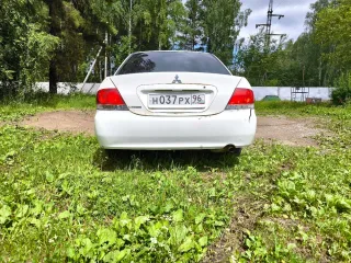 Мицубиси Лансер 2003 года выпуска номер двигателя 4G15CX0816 цвет белый