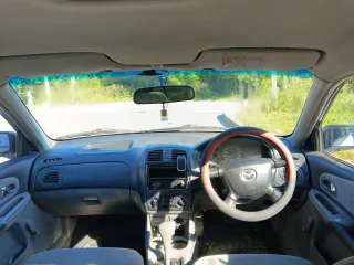 Mazda Familia, 2002. Легковой автомобиль, VIN: не установлен, мощность двигателя (кВт/л.с.): 63,75/85,0, гос. номер С224НН22. По кузову автомобиля присутствует коррозия, сгнившие пороги, арки, ржавчина на капоте, дверях и раме лобового стекла, пинается коробка с первой на вторую и не работает…