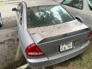 Автомобиль Mitsubishi Mirage, 1997 года выпуска, VIN: отсутствует. Тип ТС: легковой универсал, номер кузова CJ2A0102090, государственный регистрационный номер Р987СА154, паспорт транспортного средства 54НХ962098. Цвет кузова: серый.