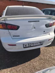 Mitsubishi Lancer 1.6, 2012 г., г/н К321ТТ18, VIN: JMBSRCY1ACU004736. Цвет кузова: белый. Объем двигателя: 1590 см³, мощность: 86 кВт (117 л.с.). Тип: легковой седан. Повреждения ЛКП, трещины на переднем и заднем бампере, коррозия. Ключи и документы отсутствуют. Обременение: залог в ПАО «Росбанк»…